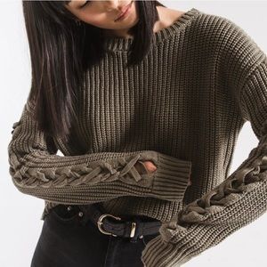 Thick green sweater with braided arms